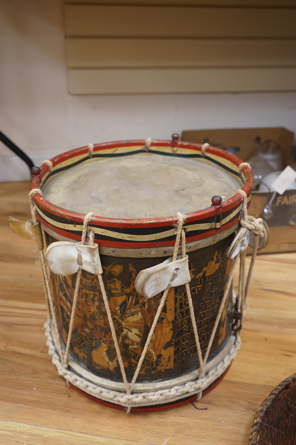 A late 19th/early 20th century Royal East Kent Regiment 'Buffs' regimental drum, 37cm diameter, 37cm high, together with a rope edged, stained pine removable 'table top' adaption